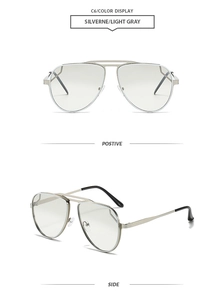 Detail of silver double-bridge pilot sunglasses with light gray lenses and metal frames
