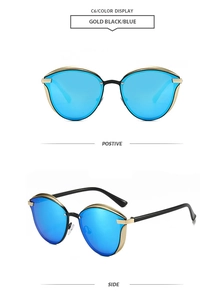 Détail de lunettes œil de chat noir et or avec verres réfléchissants bleus et vue de côté