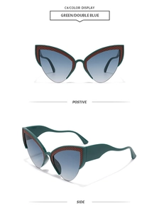 Detail view of cat-eye sunglasses with green frames and blue gradient lenses