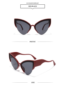 Detail of red and black cat eye sunglasses featuring honeycomb texture on frames