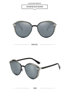 Détail de lunettes de soleil œil de chat avec monture noir argent et verres gris