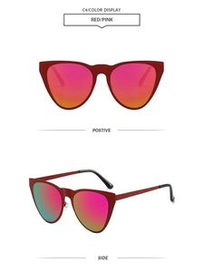 Detailed view of red cat eye sunglasses with pink to orange gradient mirrored lenses