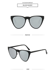 Detail view of cat eye sunglasses with black frames and silver reflective lenses