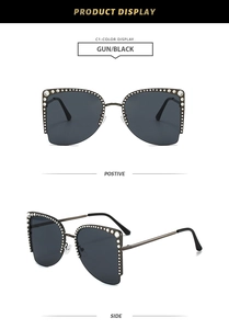 Detailansicht der gunmetal Halbrand-Sonnenbrille mit funkelndem Strassstein-Randverzierung