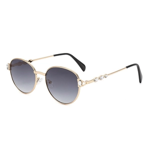 Classic round gold metal sunglasses with crystal accents and dark gradient lenses