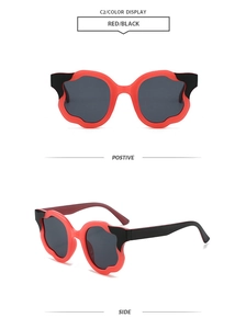 Fashionable petal-shaped sunglasses in red and black, showing front and side views.