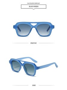 Close-up of retro double-bridge square sunglasses with blue-green frames and gradient lenses