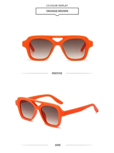 Detail view of bold orange square sunglasses with gradient lenses and double bridge design