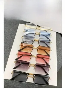 Detail of seven frameless rectangle sunglasses with gradient lenses and gold metal stems
