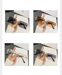 Detail view of rimless rectangle sunglasses with textured gold metal bridge and accents
