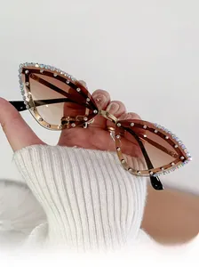 Close-up of cat-eye sunglasses with rhinestone trim and tea gradient lenses