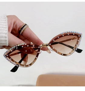 Close-up of cat-eye sunglasses with colorful rhinestones and brown gradient lenses