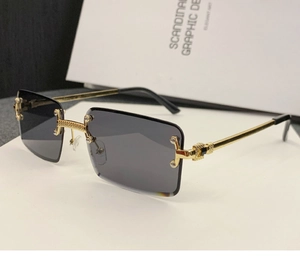Detail of rimless square sunglasses with grey gradient lenses and gold metal temples