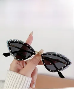 Close-up of cat-eye sunglasses with gray lenses and sparkling rhinestone embellishments