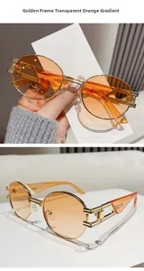 Detail of vintage oval sunglasses with gold hollow metal frame and orange gradient lenses