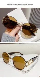 Detail of vintage oval sunglasses with golden metal frame and wood grain temples