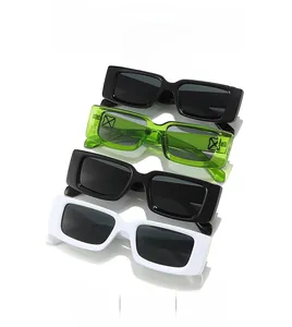 Close-up of rectangular sunglasses featuring distinctive X metal hinge decorations