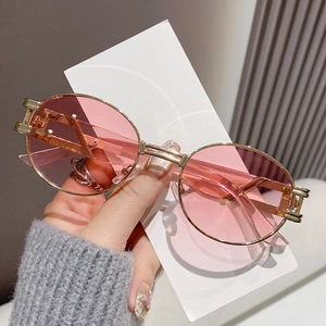 Retro oval sunglasses with pink lenses and gold metal frames for a steampunk fashion style
