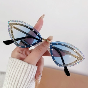 Cat eye rimless sunglasses with blue gradient lenses and rhinestone-encrusted metal frame