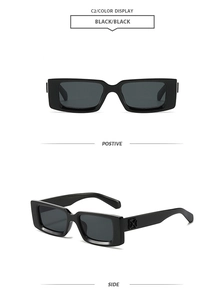 Detail of black rectangular sunglasses featuring silver cross relief on side temples