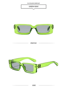 Detail view of transparent green rectangular sunglasses with grey lenses and metal trim
