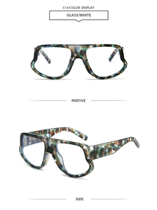 Detail view of oversized tortoise shell geometric sunglasses with thick temples