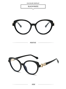 Détail de lunettes de soleil rétro rondes avec monture noire et branches dorées