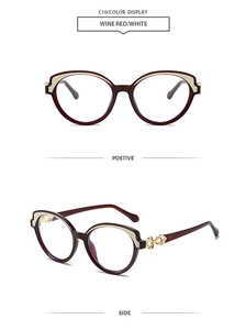 Détail de lunettes œil de chat bordeaux et blanc avec charnières dorées évidées