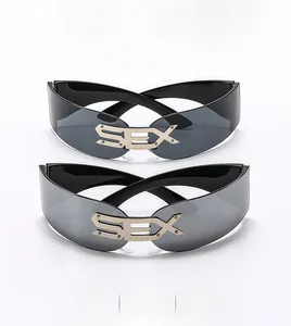 Detail of grey and silver punk frameless sunglasses with gold metal SEX logo on bridge