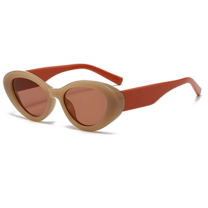 Retro cat-eye sunglasses with khaki frames and orange temples in a classic vintage style