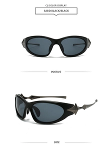 Detail of futuristic black punk sunglasses featuring silver star spikes and oval frames