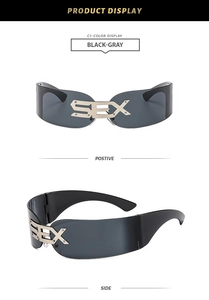 Detail view of punk rimless shield sunglasses featuring gold-toned SEX metal lettering
