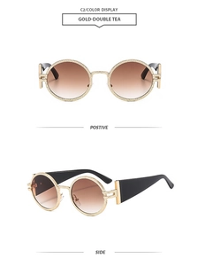 Detail of vintage oval sunglasses with gold hammered metal frames and brown gradient lenses