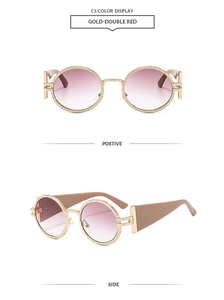 Detail of retro oval sunglasses with hammered gold metal frames and gradient pink lenses