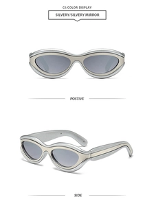 Macro detail of futuristic silver cat eye sunglasses with layered metallic oval frame