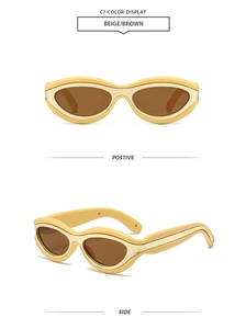Detail view of beige cat-eye sunglasses with gold metal inlay and brown lenses