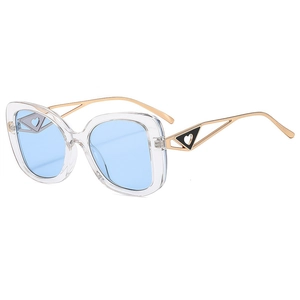Retro cat-eye sunglasses with transparent frame, light blue lenses and heart metal temples