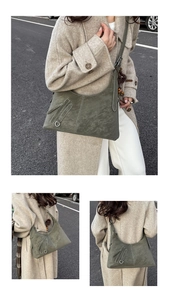 Detail of dark green hobo bag with contrast stitching and decorative metal rings