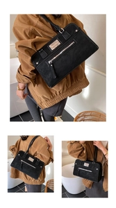 Détail d'un grand sac cabas en daim noir avec poche zippée et design élégant pour le bureau