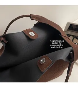 Detail shot of brown woven bucket bag featuring a secure magnetic snap button closure