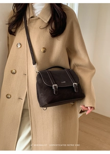Close-up of retro minimalist tote bag with double buckle flap and CLEAR logo detail