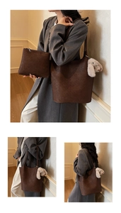 Macro shot of dark brown woven tote bag with matching pouch and plush rabbit charm