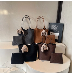 Detail of woven tote bags set in four colors with cute plush rabbit charms and inner pouches