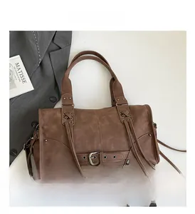 Detailed view of brown retro Boston bag with braided drawstrings and metal rivets