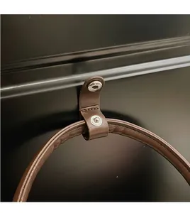 Macro shot of brown pebble grain leather strap with silver metallic snap button detail
