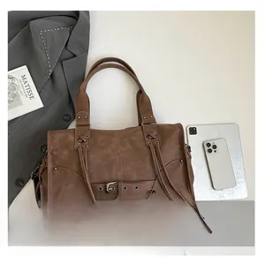 Flat lay of vintage brown leather tote bag with large capacity and retro buckle detail
