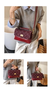 Close-up of diamond lattice stitching and metallic rotary lock on burgundy handbag