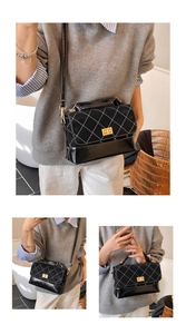 Detail of black quilted crossbody bag with gold lock and textured contrast finish