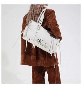 Fashionable white leather tote bag styled with a brown blazer on model back view