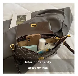 Internal capacity of the quilted brown crossbody bag showing space for phone and makeup